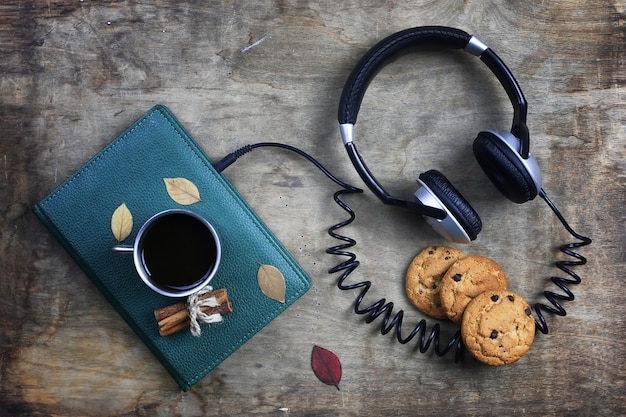 Audiobook headphones and book on a wooden table