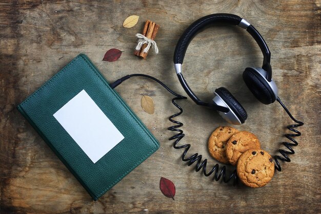 Audiobook headphones and book on a wooden table