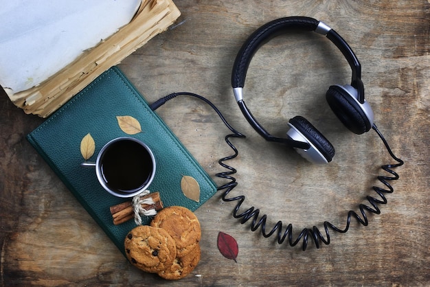 Audiobook headphones and book on a wooden table