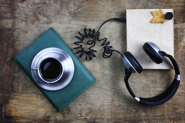 Audiobook headphones and book on a wooden table