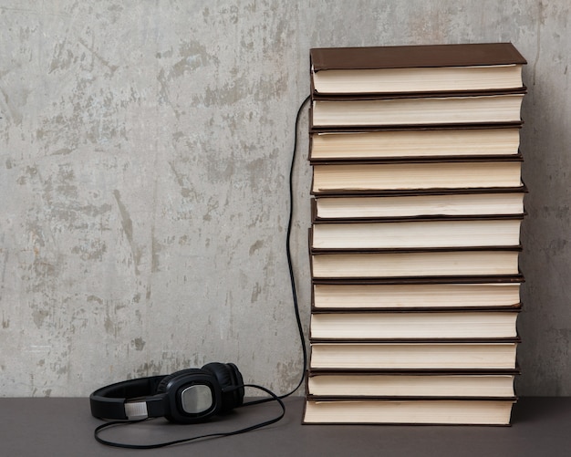 Audiobooks, headphones on book pile