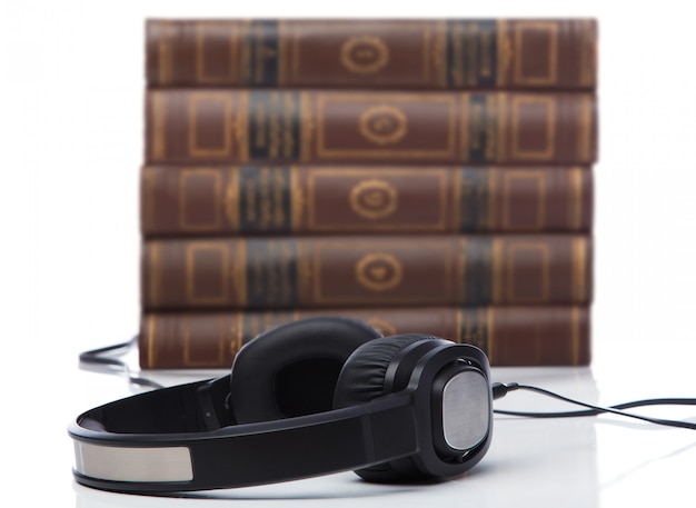 Audiobooks, headphones on book pile