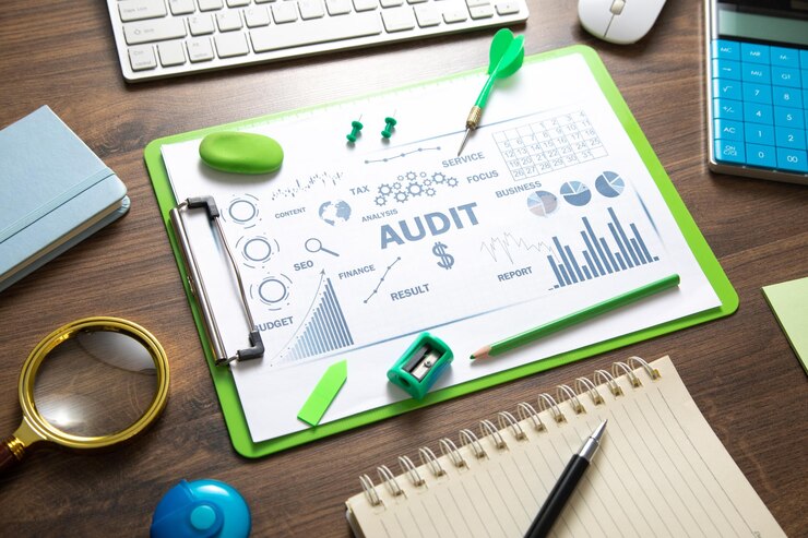 Photo audit business charts objects graphs and words business concept