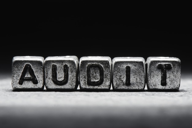 Photo audit concept. 3d inscription on metal cubes on a gray black background isolated