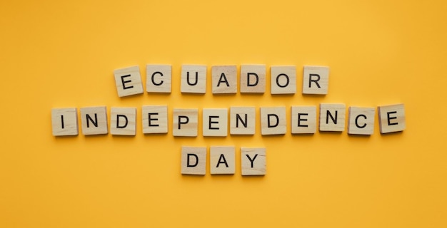 August 10 independence day in ecuador a minimalistic banner with an inscription in wooden letters on an orange background