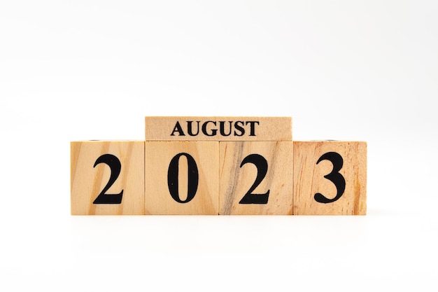 August 2023 written on wooden blocks isolated on white background with copy space