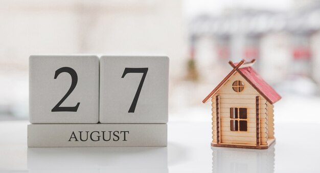 August calendar and toy home. Day 27 of month. Card message for print or remember