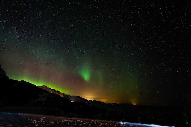 Aurora borealis over dark the mountains in Lofoten Islands