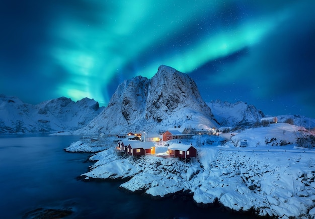 Фото Северное сияние лофотенские острова норвегия зимний пейзаж с северным сиянием вид на дома в поселке хамной лофотенские острова норвегия