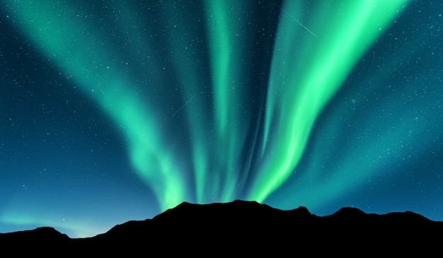 Aurora borealis and silhouette of mountains