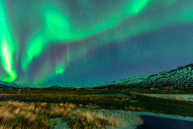 Aurora rising above a beautiful mountain. In iceland