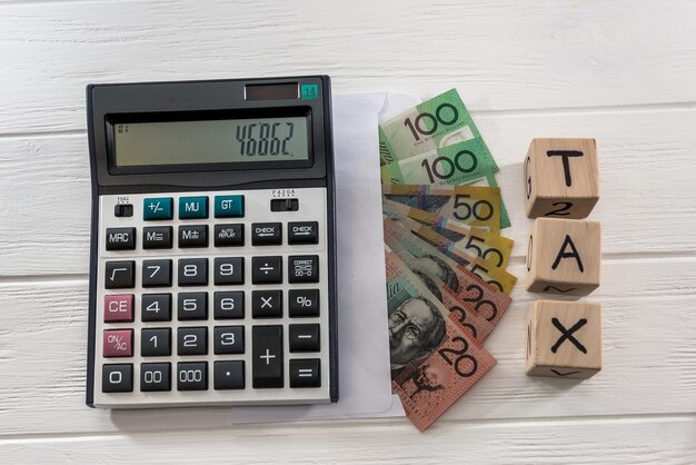 Australian dollar banknotes with wooden cubes and calculator