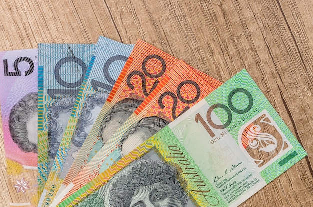 Photo australian dollar on wooden table close up