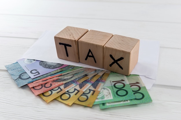 Australian dollars in envelope with wooden cubes