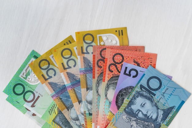 Photo australian dollars in fan on wooden table, closeup