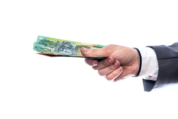 Australian dollars in male hand isolated on white