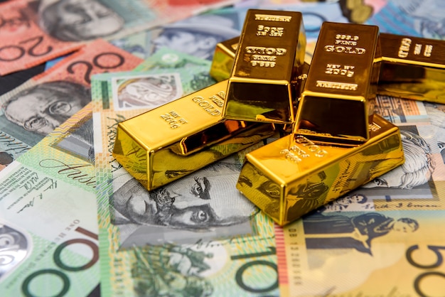 Australian dollars with gold ingots close up