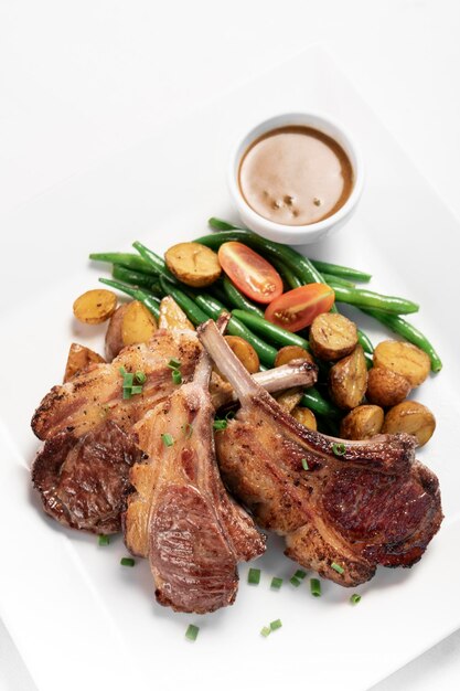 Photo australian organic lamb chops with gravy meal on white backgroundv