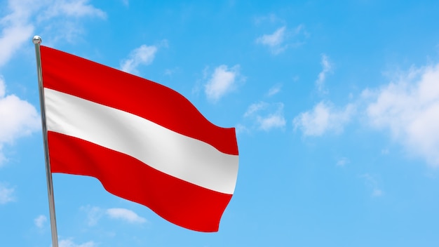 Фото Флаг австрии на шесте. голубое небо. государственный флаг австрии