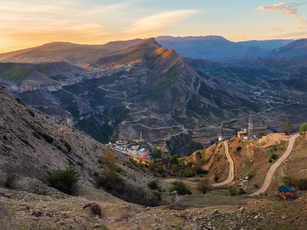 Authentic city with serpentine dirt road in the rock Vintage Dagestani mountain village of Gunib in sunrise Russia