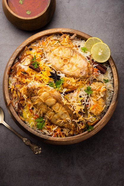 Authentic Fish Biryani served in a white plate or handi