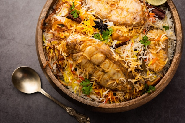 Authentic Fish Biryani served in a white plate or handi