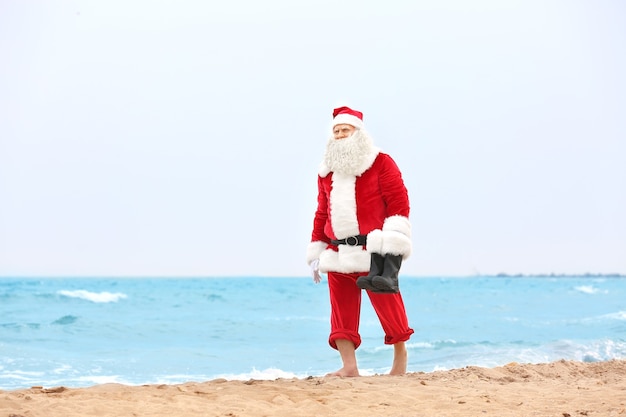 Authentic Santa Claus walking on beach