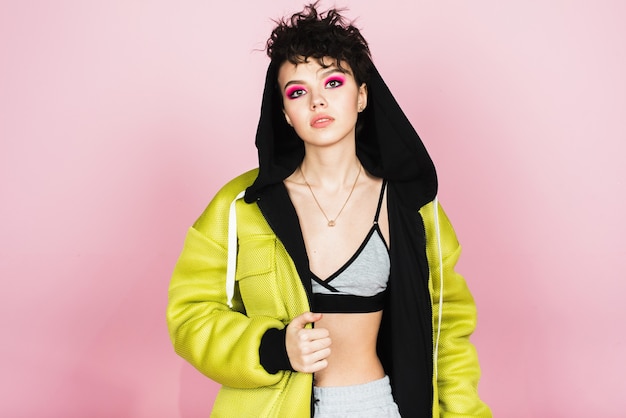 Authentic studio portrait. A young girl in a tracksuit and with a press