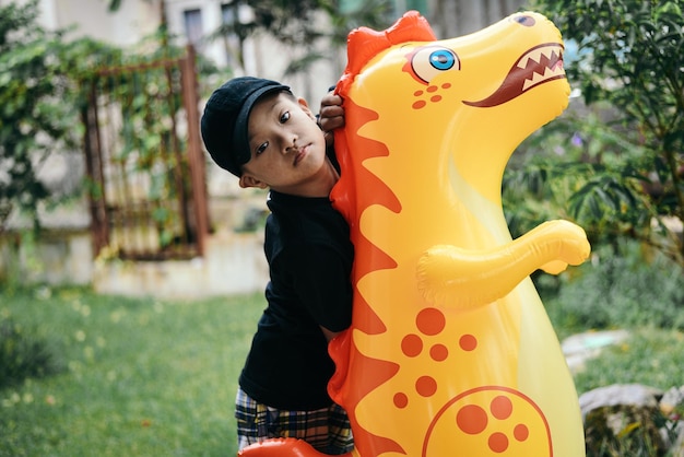 An autism boy playing with toy standing outdoors