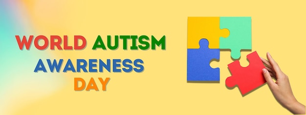 autism day puzzle piece hand and text on a yellow background