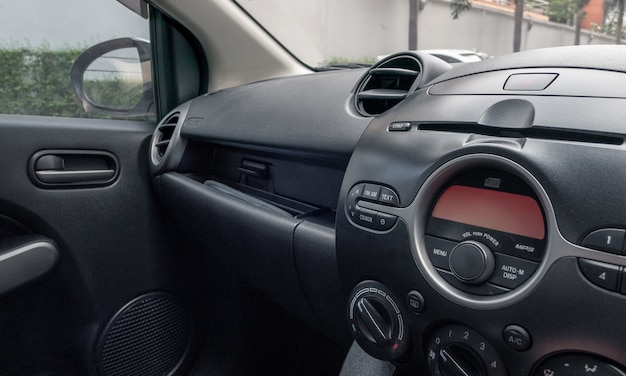 Auto binnen bestuurdersplaats. Voorstoelen met dashboardbediening.