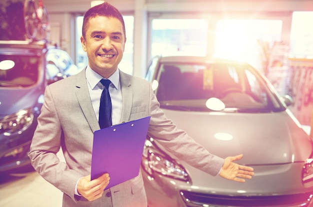 auto business, car sale, consumerism and people concept - happy man at auto show or salon