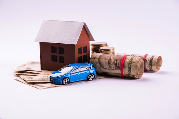 Photo auto finance and housing loan or purchase in india -  concept showing 3d car and house model, keys, indian currency notes and calculator etc