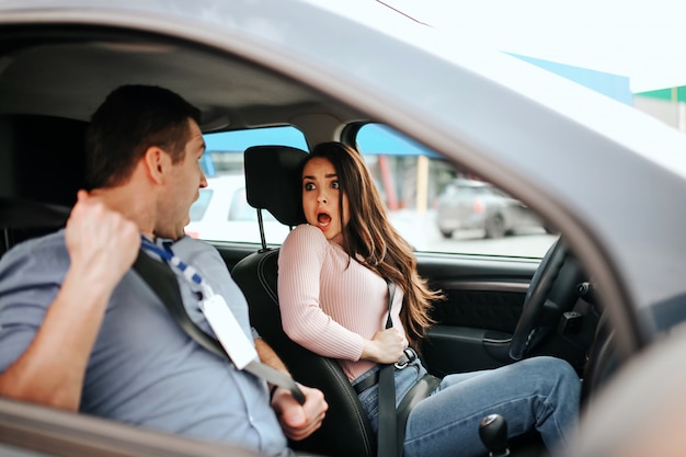 Istruttore automatico e apprendista in auto tenere le cinture di sicurezza