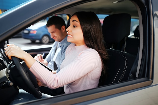 Auto instructor and student in a car