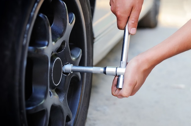 Auto mechanic changing car wheel