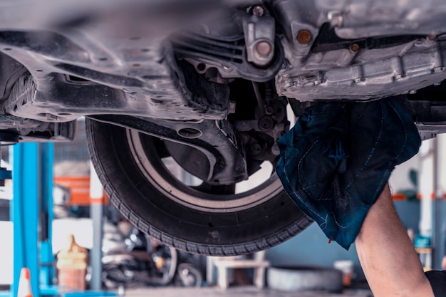 Photo auto mechanic changing oil machine.    the man is changing the motor oil.change engine oil.replacement of automobile oil.check the auto maintenance.transportation repair service center