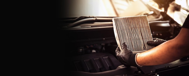 Auto mechanic checking cleaning and replacing car air filter\
concept of car care service maintenance