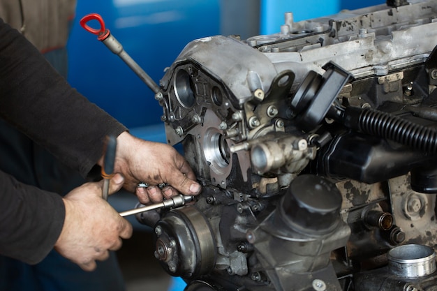 Auto mechanic checking an internal combustion engine