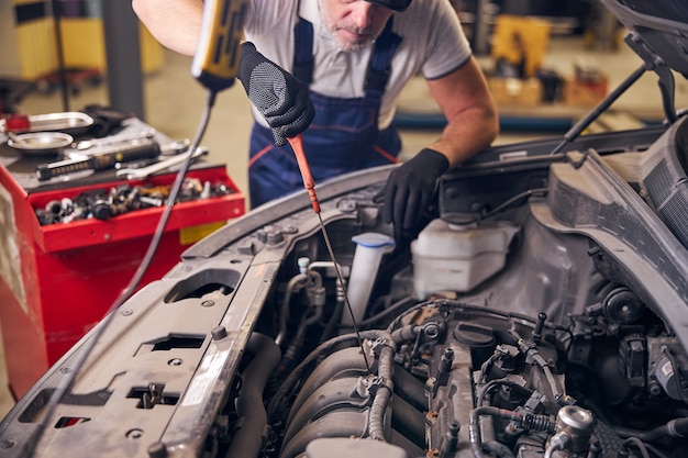 Auto mechanic fixing car at repair service station