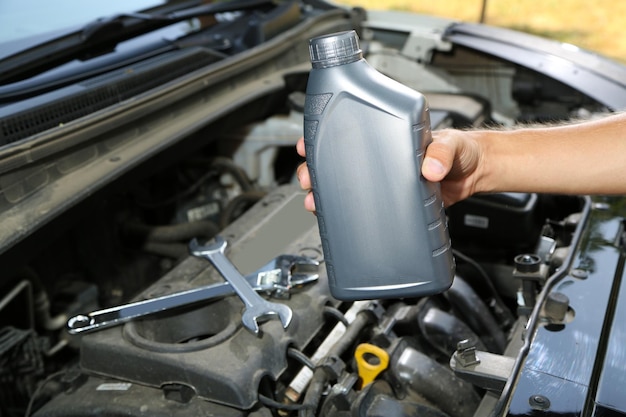 Auto mechanic hand holding motor oil