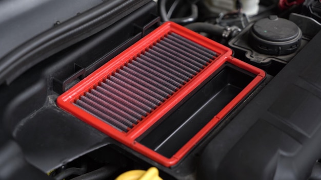 An auto mechanic is cleaning the engine compartment car service closeup