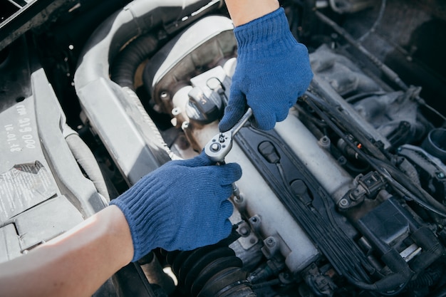 An auto mechanic repairing a car engine