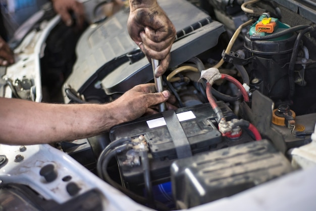 Auto mechanic repairing car. Selective focus.