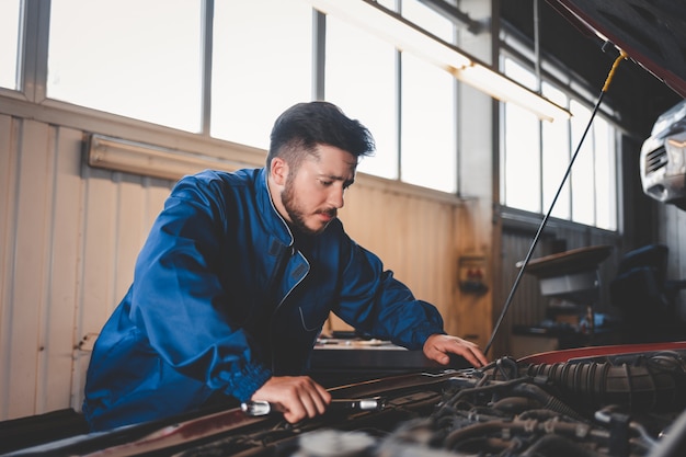 auto mechanic repairing cars in the service garage