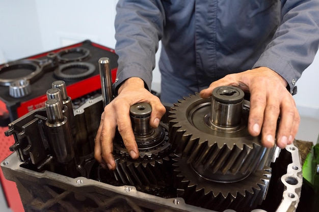 An auto mechanic repairs a truck engine Service of trucks in the garage Closeup