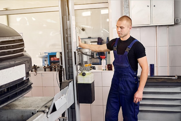 Auto mechanic sets the car for diagnostics and configuration collapseconvergence Car Wheels alignment equipment on stand in a repair station