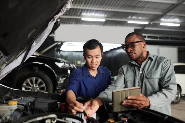 Auto mechanic talking to client