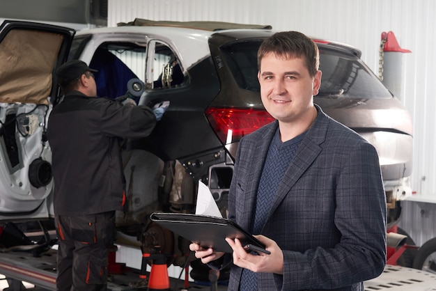 Auto mechanic and technician working in repair shop