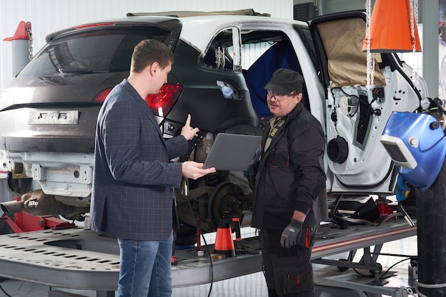 Auto mechanic and technician working in repair shop